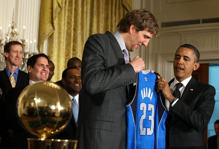 WASHINGTON, DC - JANUARY 09:  President Barack Obama (R) is given a jersey from Dirk...