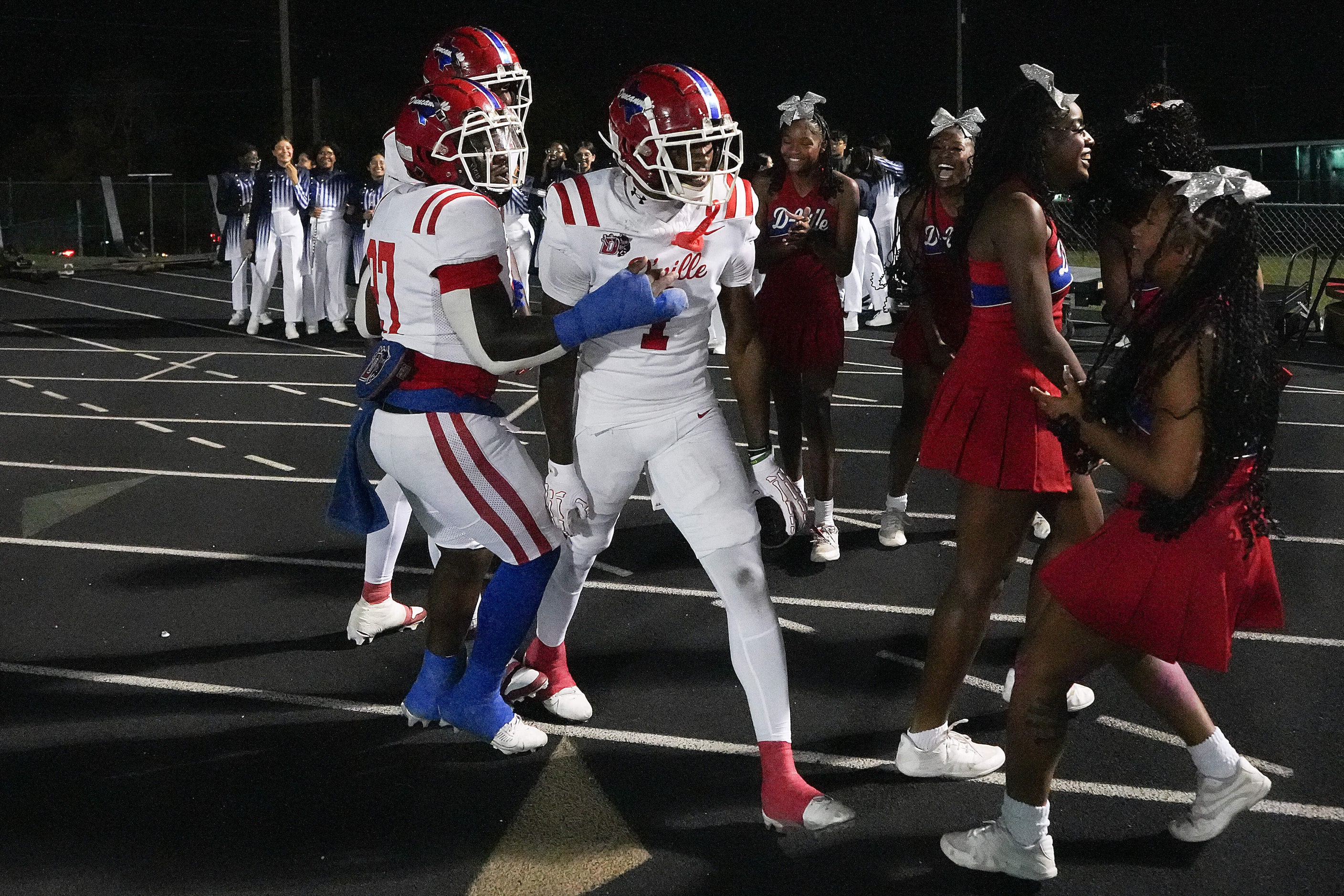 Duncanville wide receiver Dakorien Moore (1) celebrates with teammates and cheerleaders...