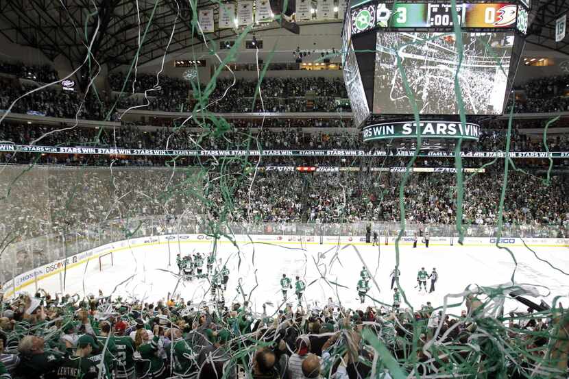 Dallas Stars fans and team celebrate a victory over the Anaheim Ducks in game 3 of a first...