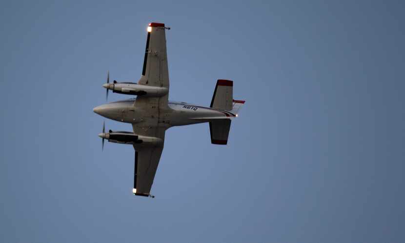 A Beechcraft airplane sprays the insecticide DUET over Addison to curb the spread of West...