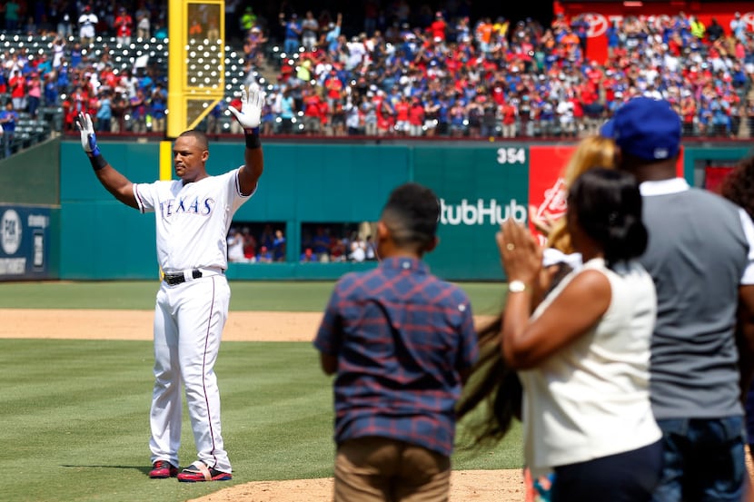 Texas Rangers Adrian Beltre (29) waves to the crowd as his family looks on after hitting his...