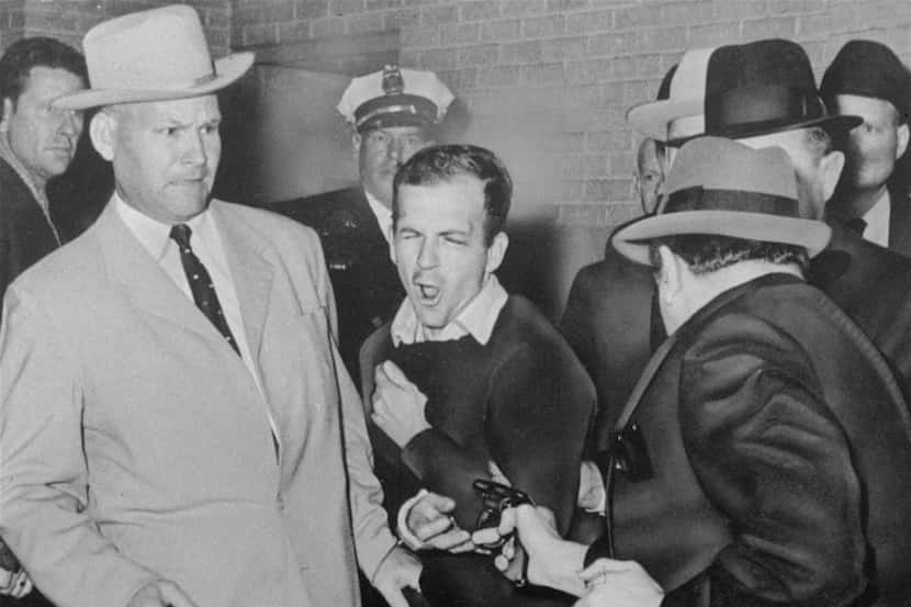 Lee Harvey Oswald is shot by Dallas night club owner Jack Ruby at point blank range in a...