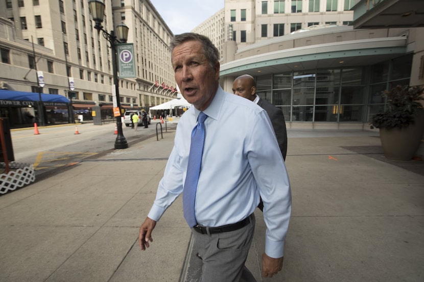 Ohio Gov. John Kasich leaves a mall housing the Ritz Carlton Hotel in downtown Cleveland on...