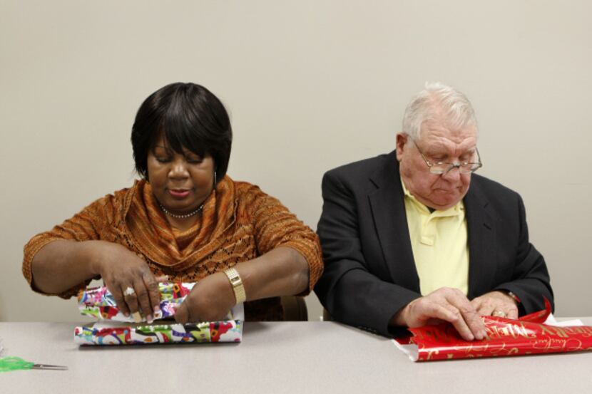 Volunteers Pearline Harper and Johnny Spannagel wrapped Christmas presents at Brother Bill's...
