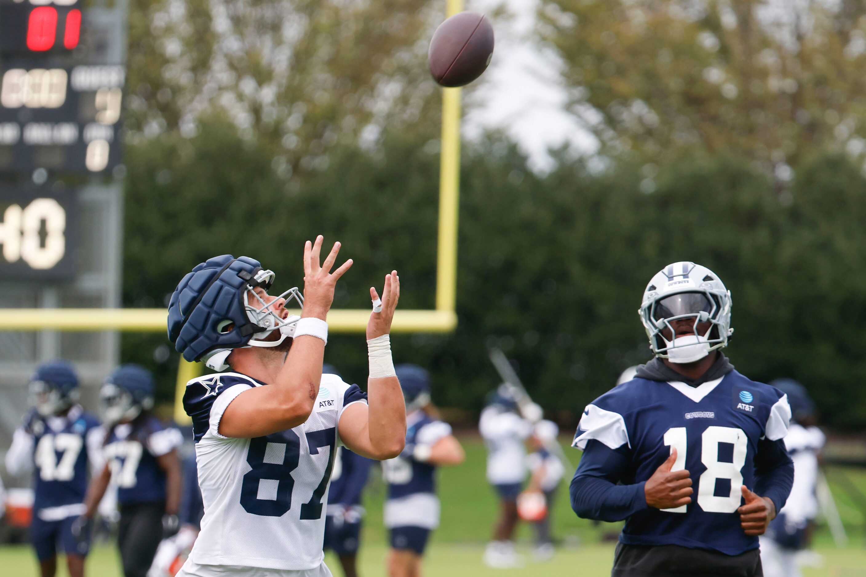 Dallas Cowboys tight end Jake Ferguson (87)  reaches to receive a throw during a team...