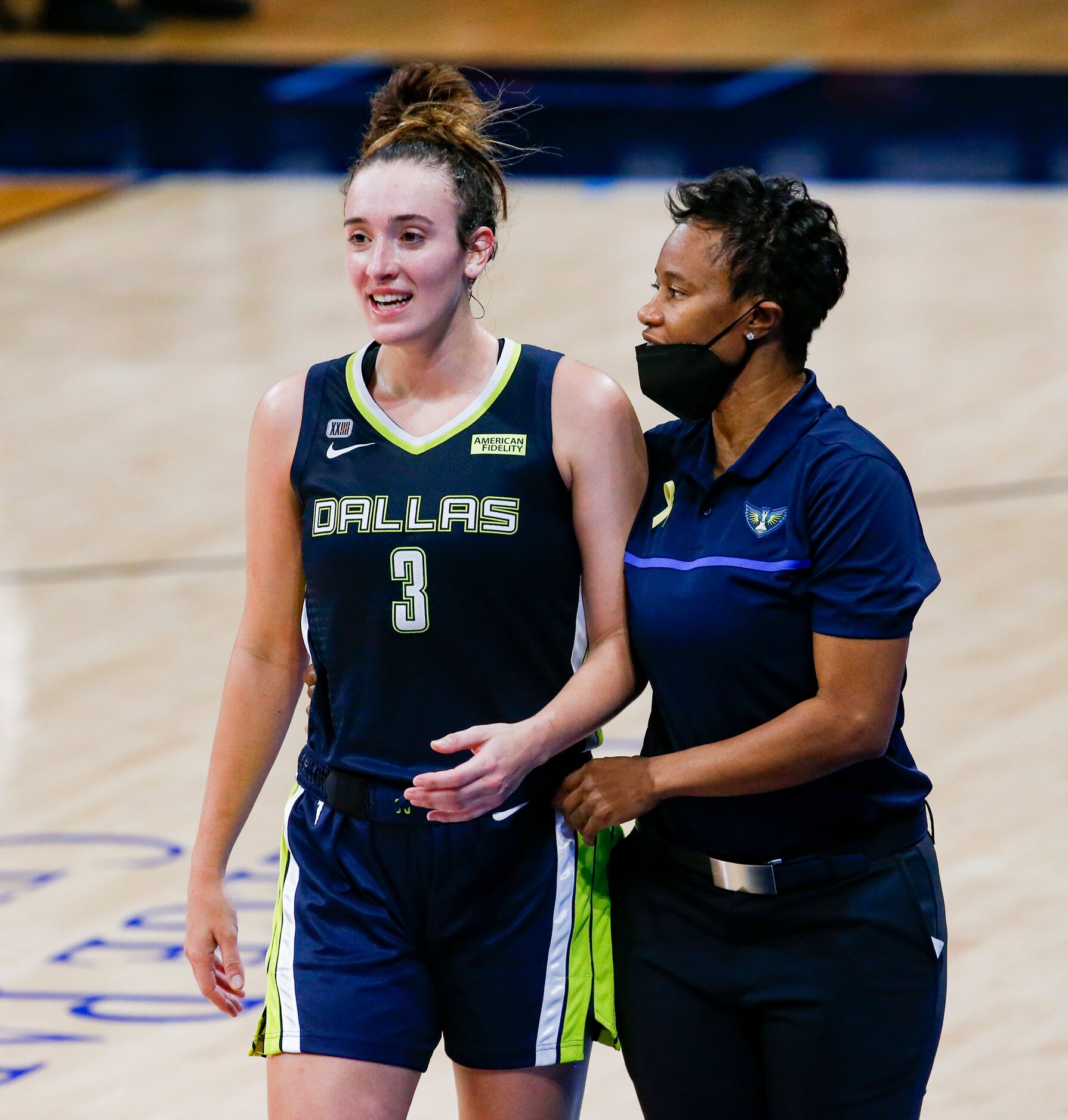 Dallas Wings guard Marina Mabrey (3) talks to coach Vickie Johnson on the sideline during...