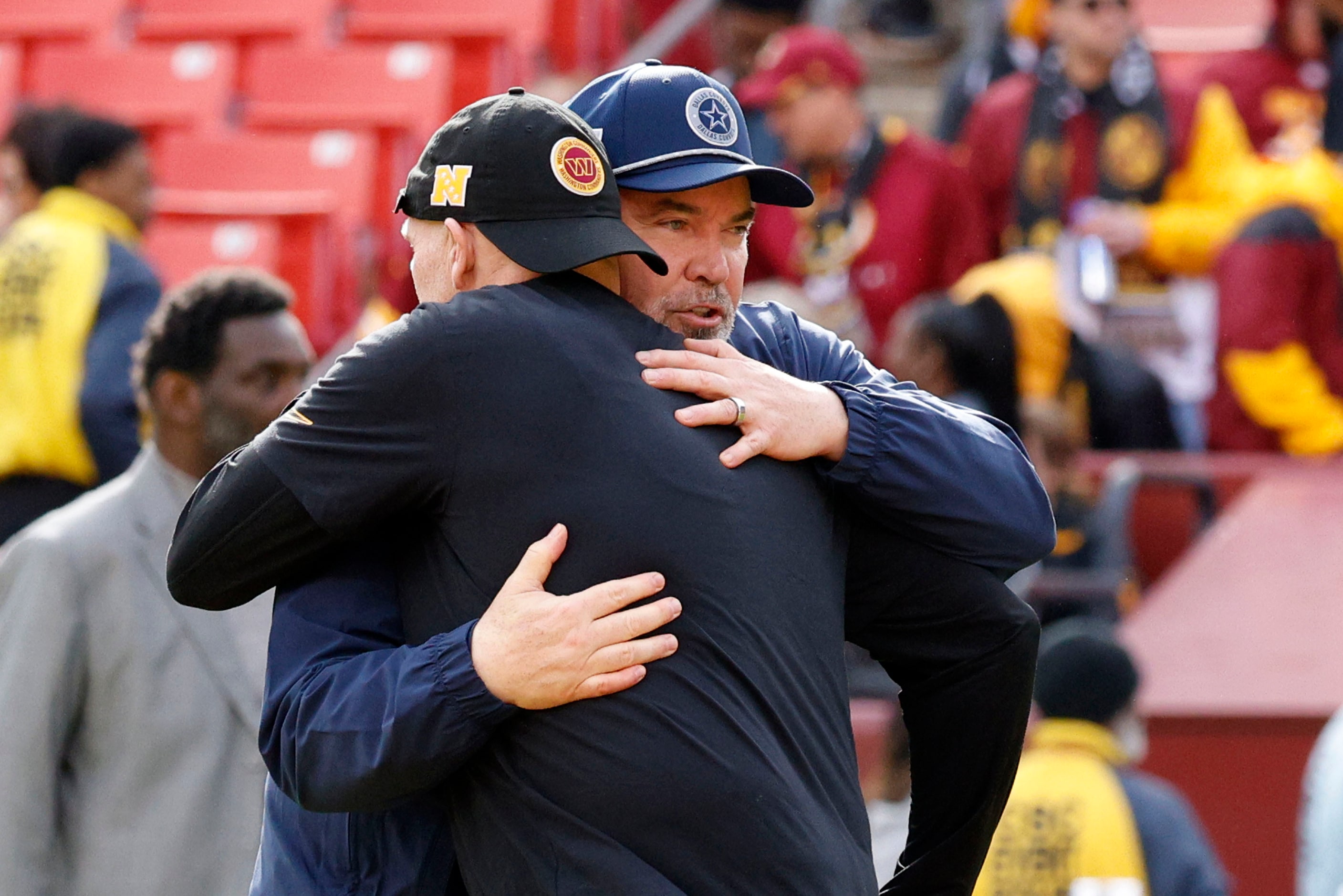 Washington Commanders head coach Dan Quinn  hugs Dallas Cowboys head coach Mike McCarthy...