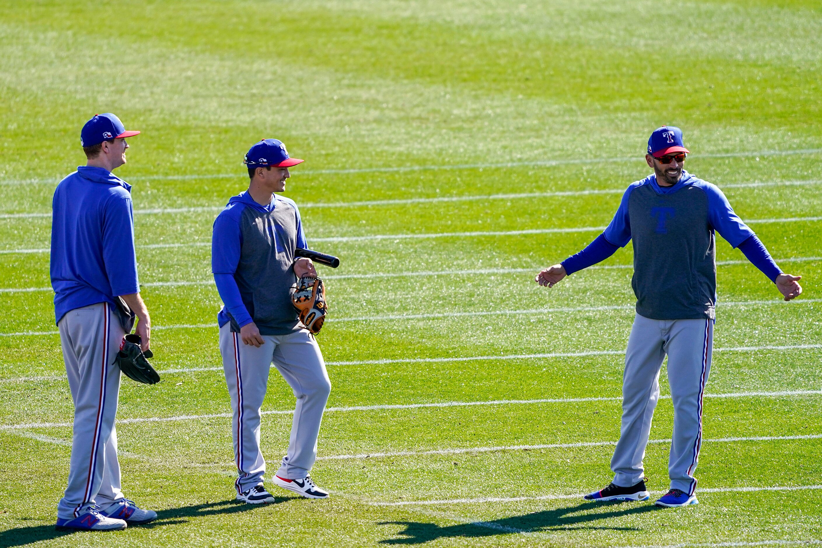 Texas Rangers manager Chris Woodward (right) talks with AAA Nashville manager Darwin Barney...