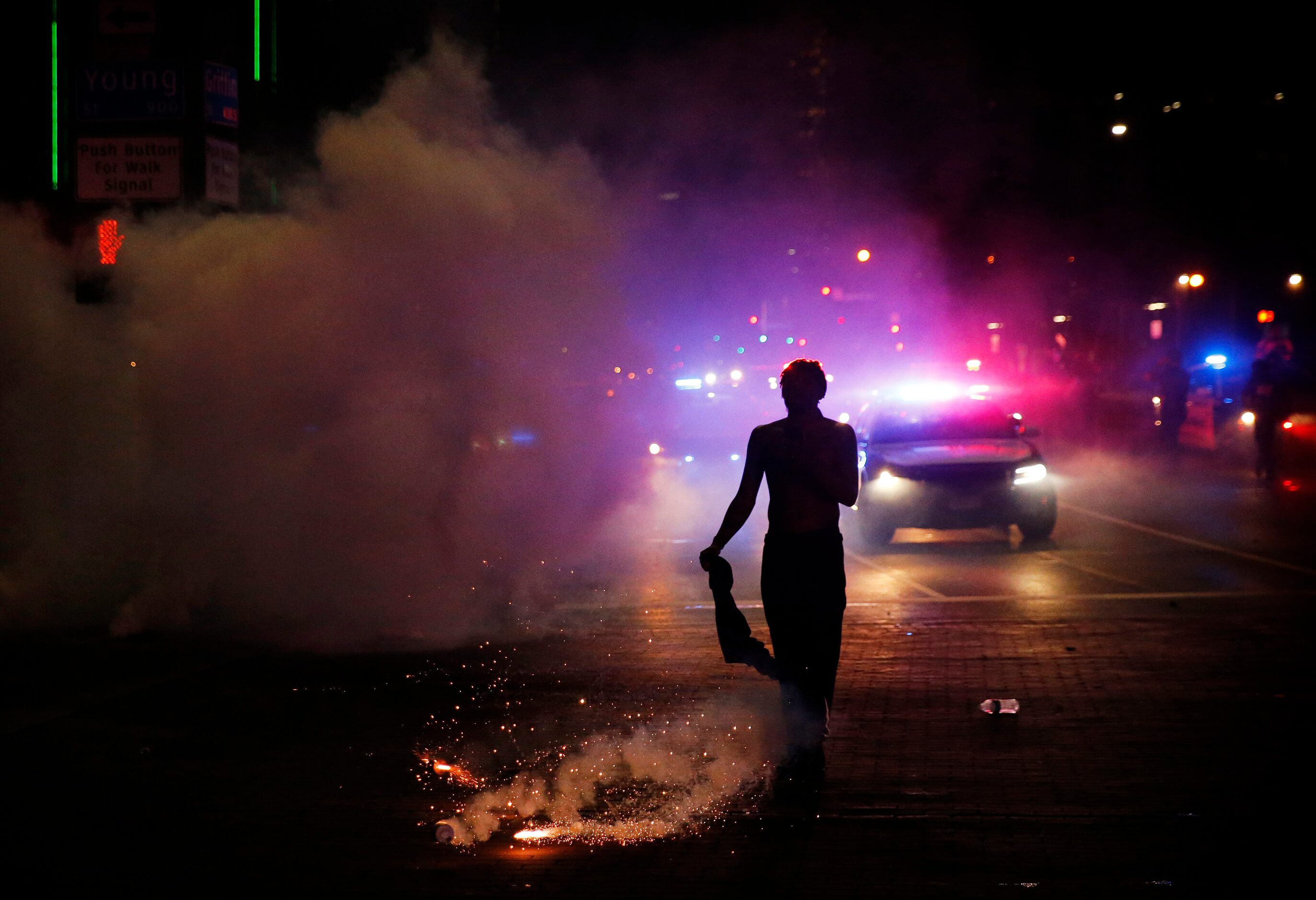 A protestor is nearly hit by a tear gas canister at the intersection of Young St. and S....