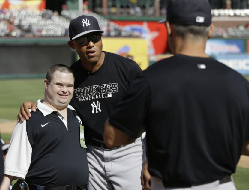 New York Yankees relief pitcher Mariano Rivera poses with fan Richard Payton of Leander as...