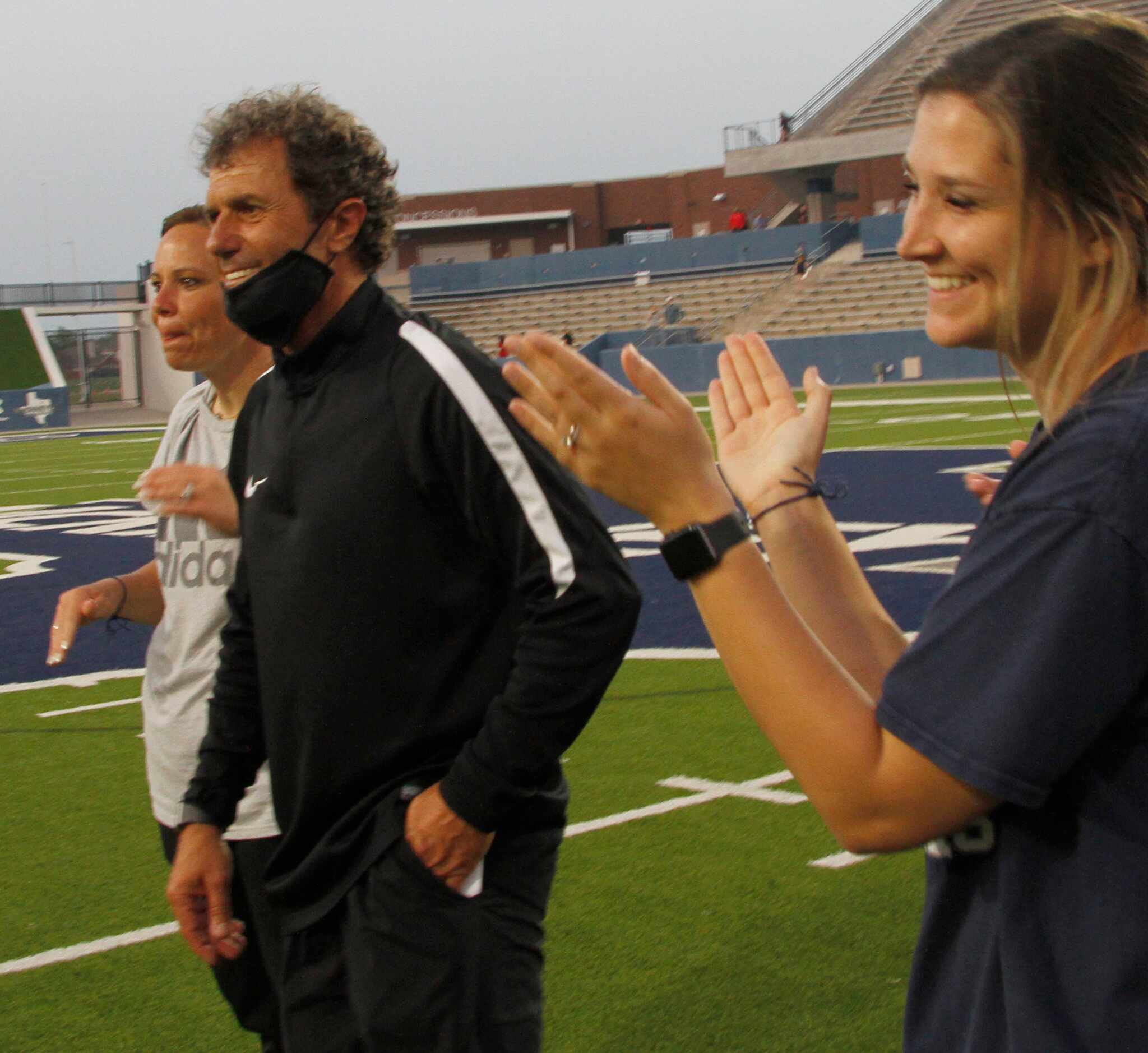 Flower Mound head coach Misail Tsapos beams as he steps beck to allow the spotlight as they...