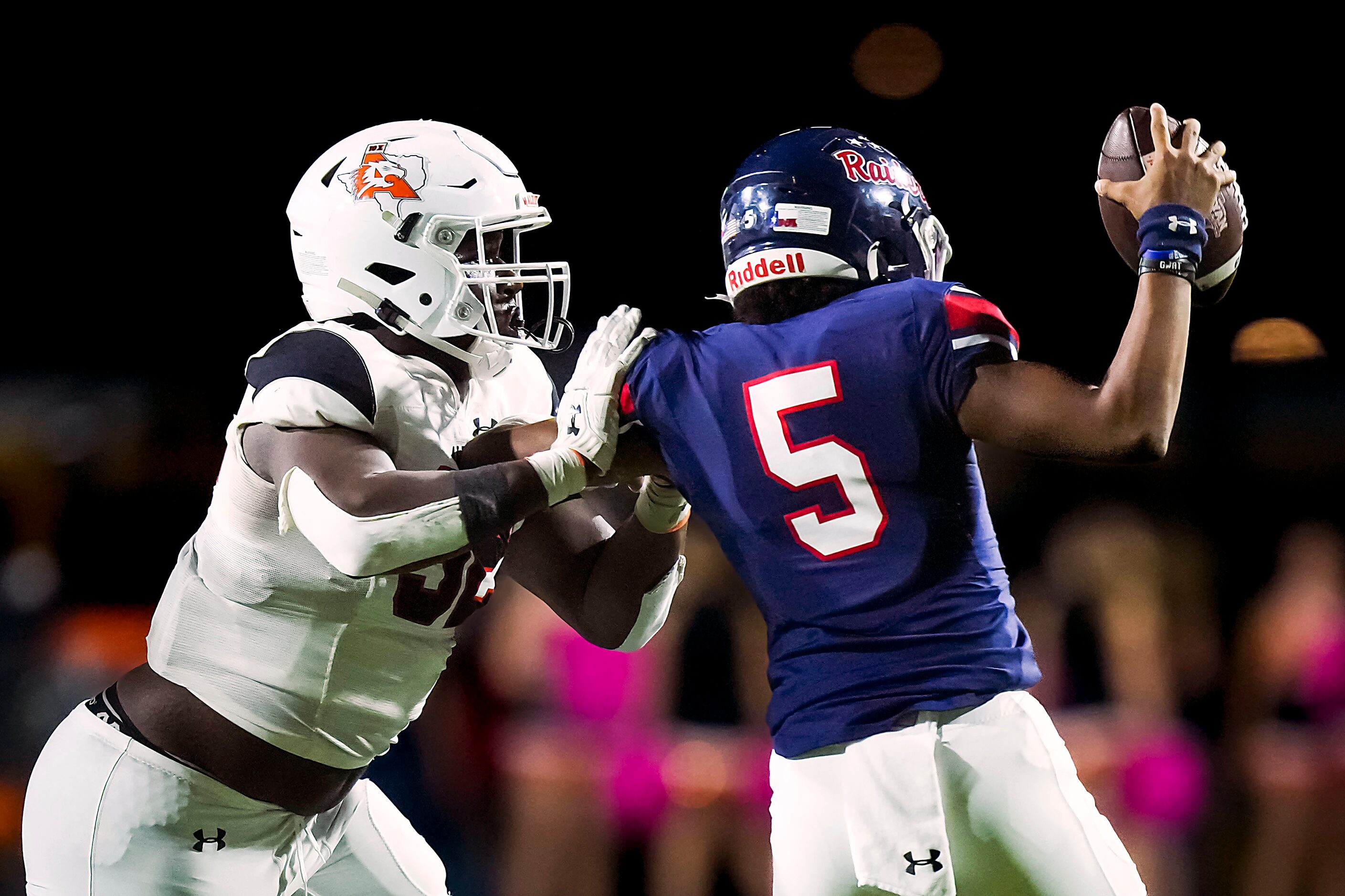 Denton Ryan quarterback Khalon Davis (5) tries to pass as he is pulled down by Aledo...