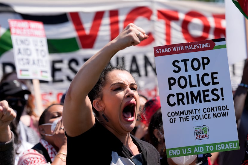 A protester yells during a demonstration before a march to the Democratic National...