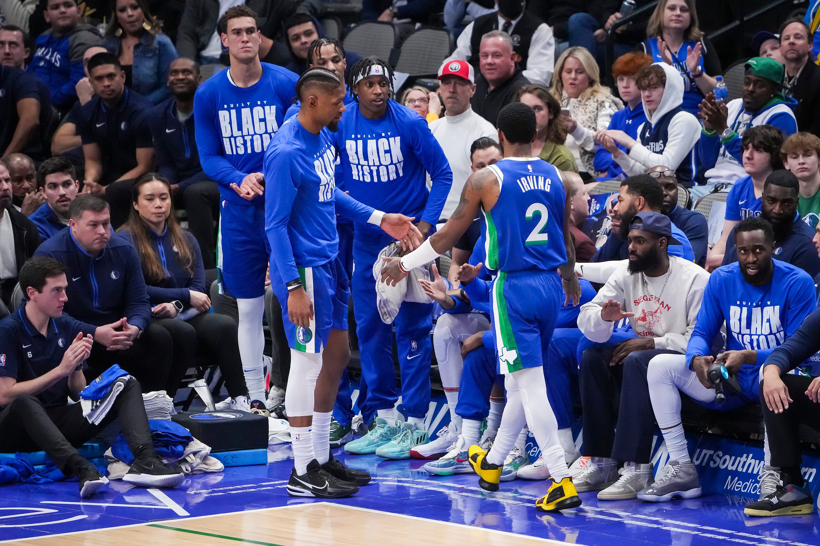 Dallas Mavericks guard Kyrie Irving (2) gets a hand as he checks out of the game during the...