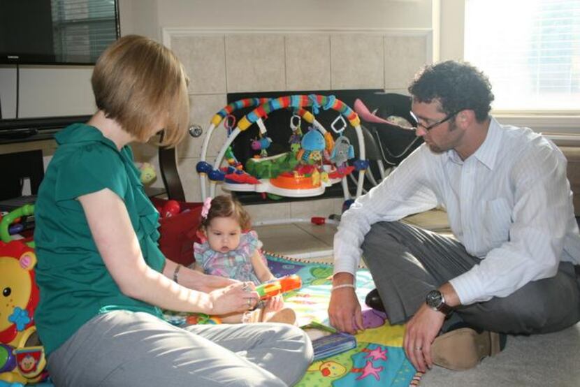 
Sarah and Brandon Turman play with their daughter, Ava, 1, who is on the list for a small...