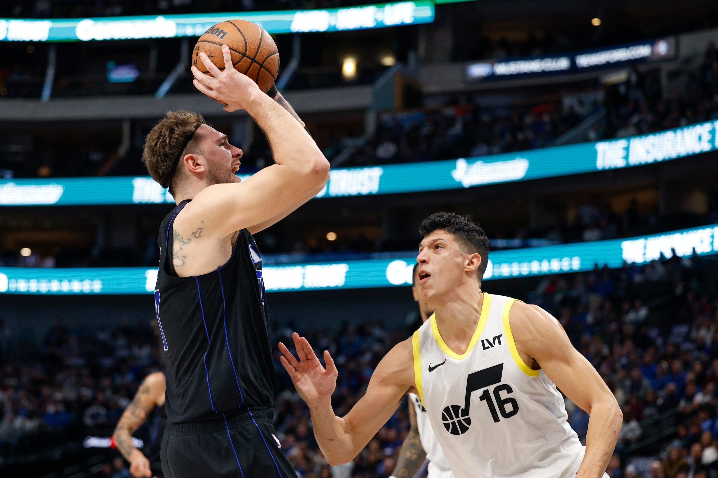 Dallas Mavericks guard Luka Doncic (77) shoots over Utah Jazz forward Simone Fontecchio (16)...