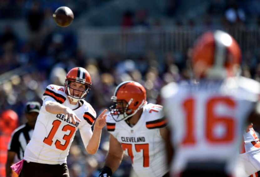 Cleveland Browns quarterback Josh McCown, left, throws to wide receiver Andrew Hawkins (16)...