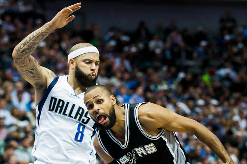 Dallas Mavericks guard Deron Williams defends as San Antonio Spurs guard Patty Mills tries...