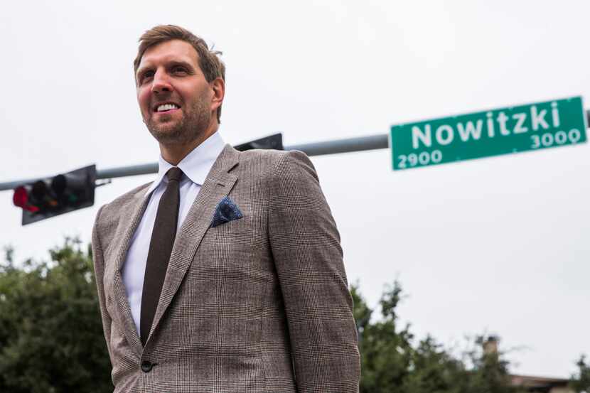 Retired Dallas Mavericks player Dirk Nowitzki poses for photos after unveiling a street sign...
