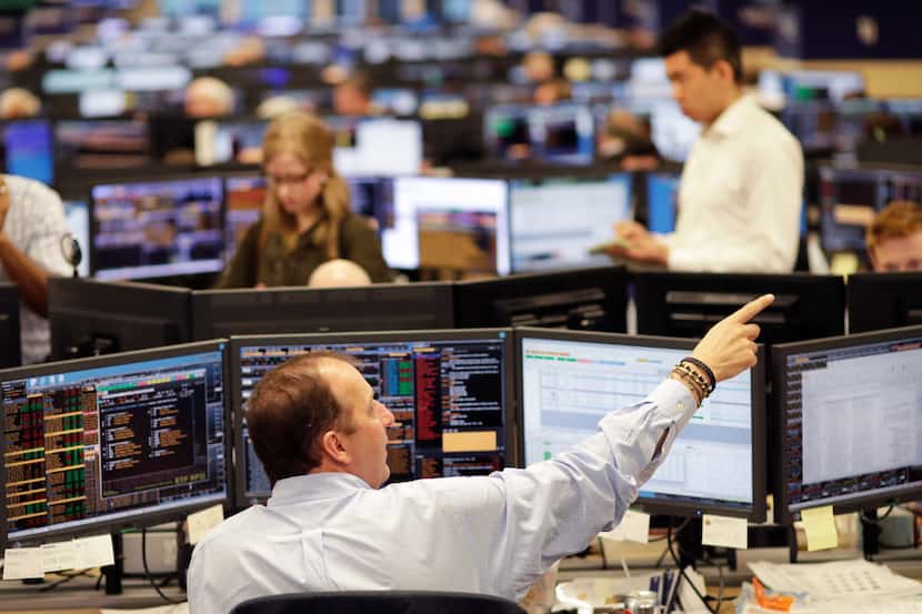 In this Jan. 12, 2017 photo, traders work on the Mizuho Americas trading floor in New York....