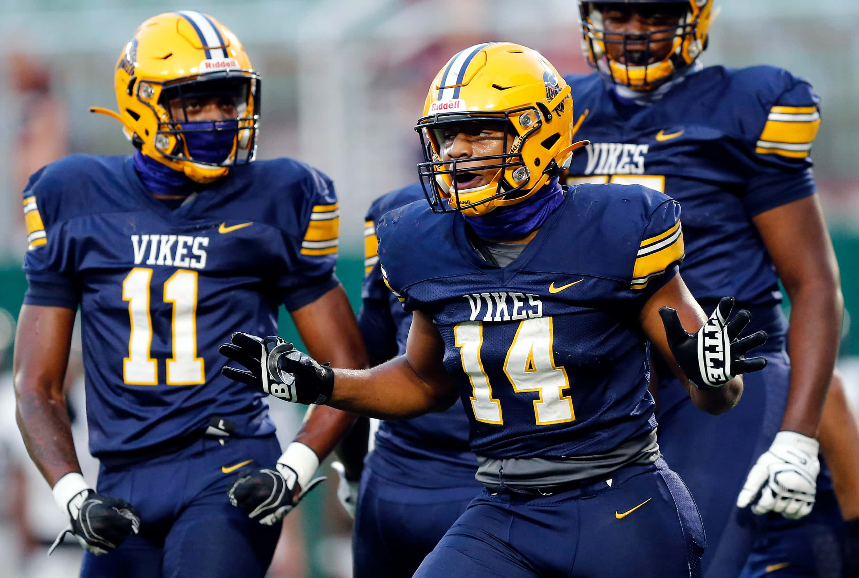 Arlington Lamar running back Caleb Phillips (14) celebrates his first quarter touchdown run...