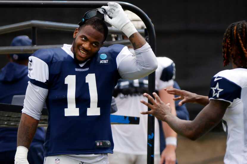 Dallas Cowboys outside linebacker Micah Parsons (11) laughs with wide receiver CeeDee Lamb...