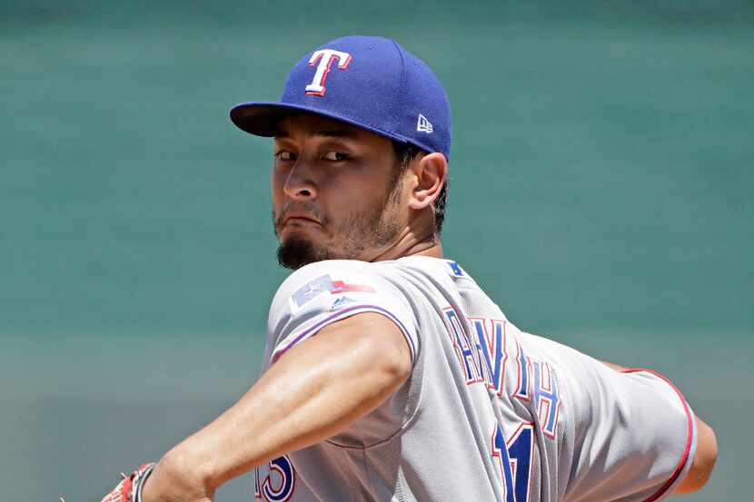 Texas Rangers starting pitcher Yu Darvish throws during the second inning of a baseball game...