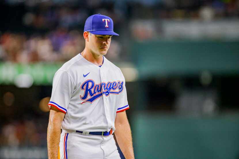 Texas Rangers pitcher Cody Bradford walks to the dugout after the second inning of a...