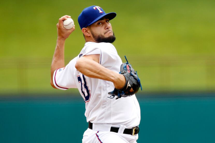 FILE - Texas Rangers starting pitcher Martin Perez (33) throws in the third inning against...