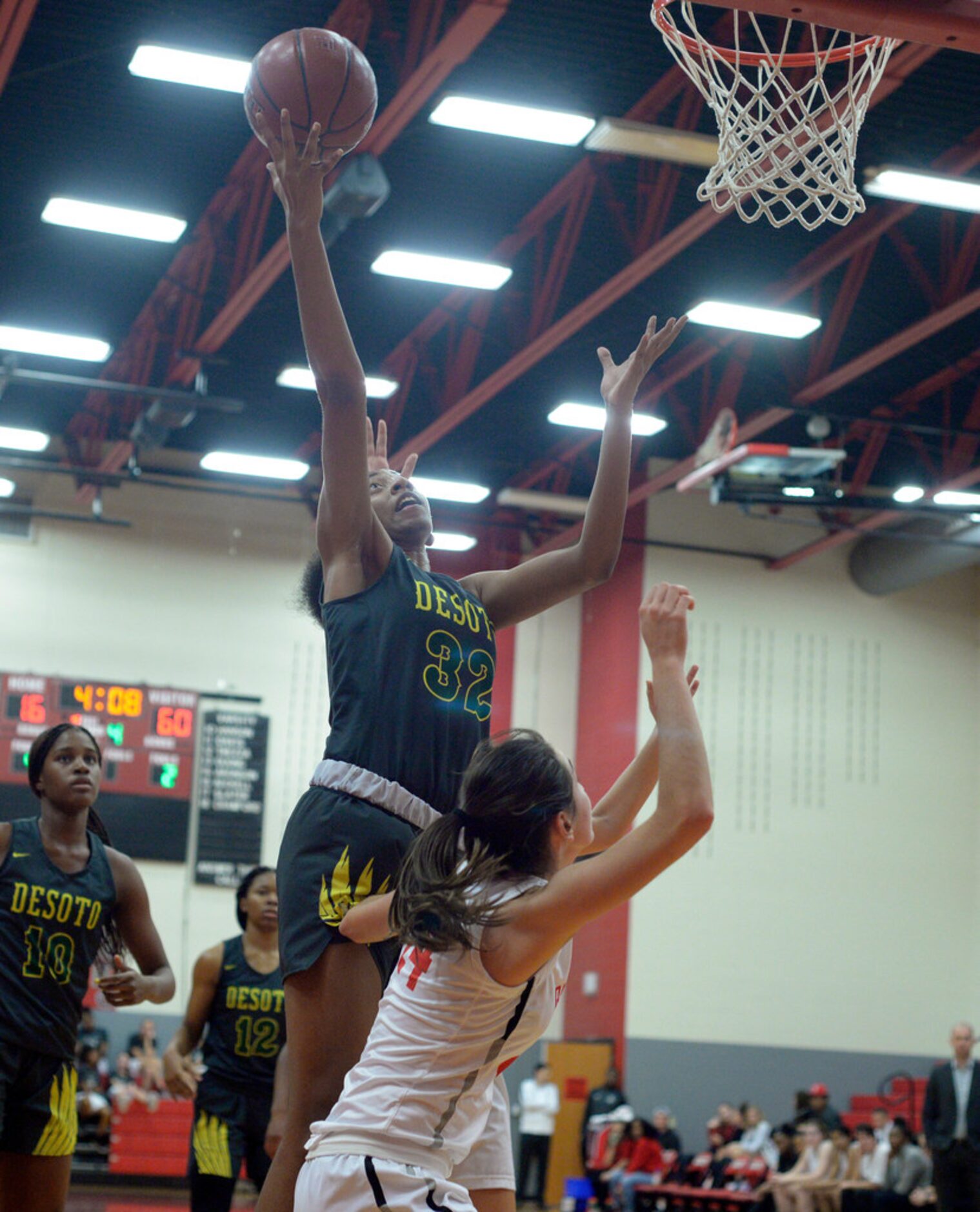 DeSoto's Tionna Herron (32) grabs a rebound in the second half during a girls high school...