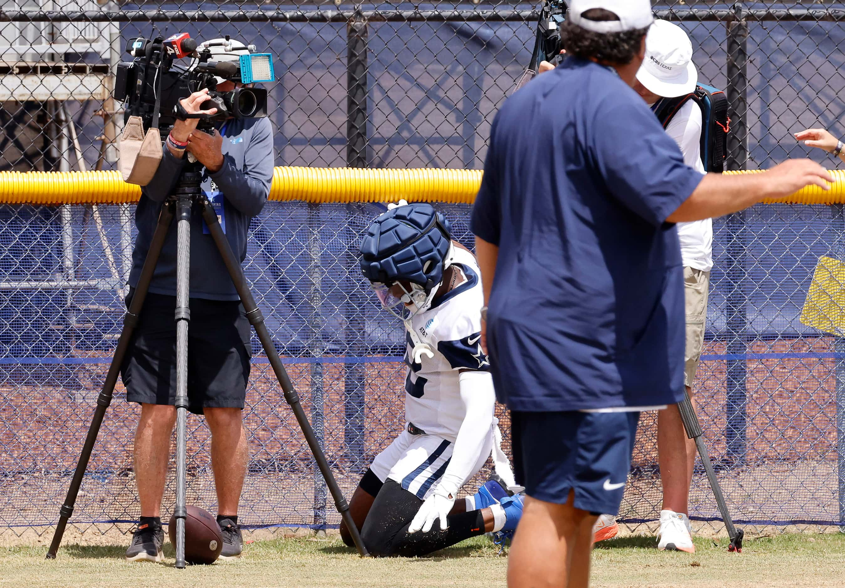 Dallas Cowboys wide receiver Ryan Flournoy (18) collapses after running into a fence on a...