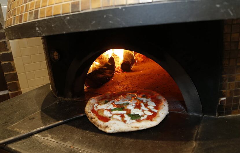 A margherita pizza comes out of the wood fired oven at Pizzeria Testa.