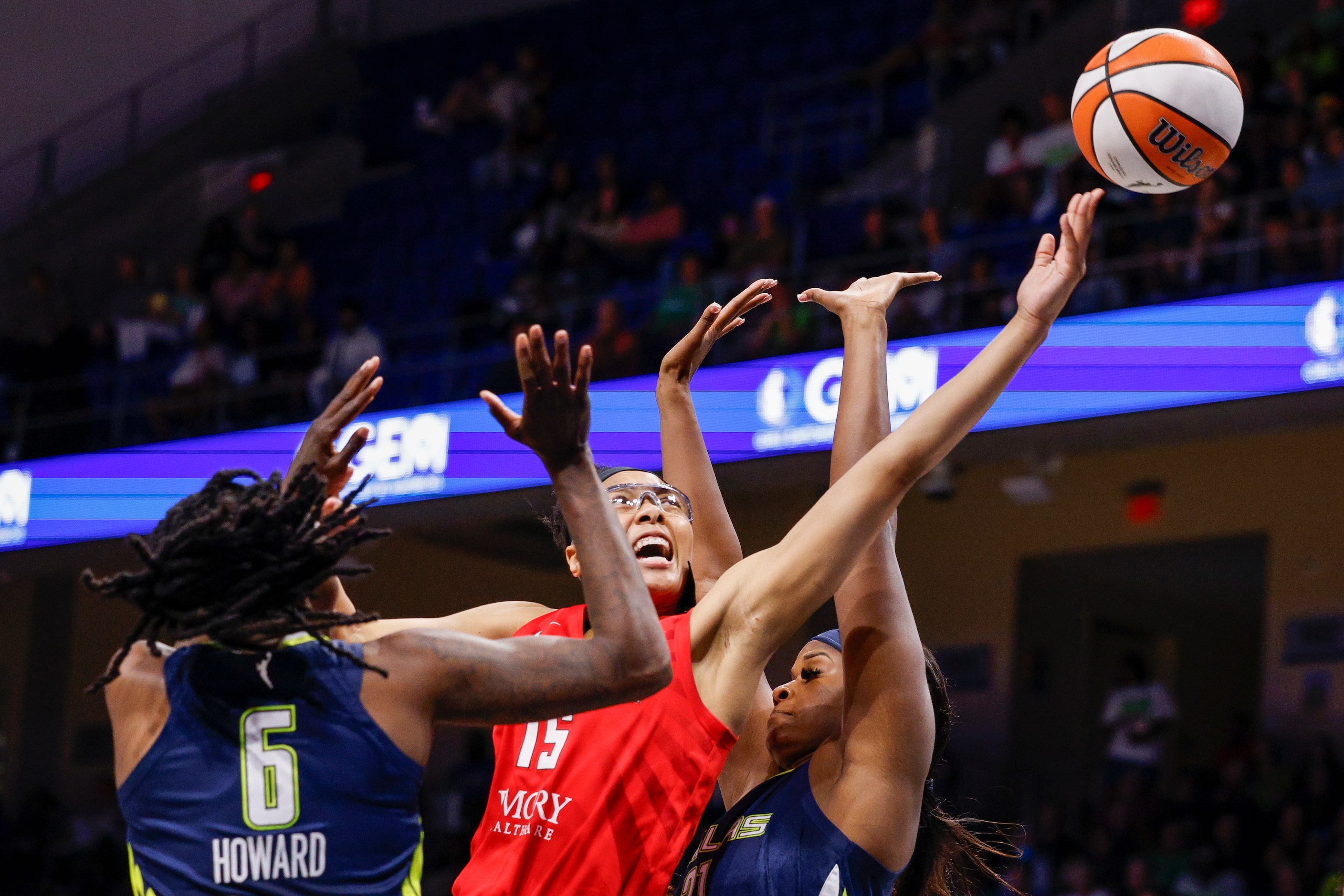 Atlanta Dream guard Allisha Gray (15) drives to the basket between Dallas Wings forward...