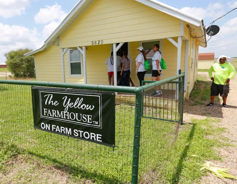 Students and staff from All About U Tweeners enter The Yellow Farmhouse in Waxahachie....