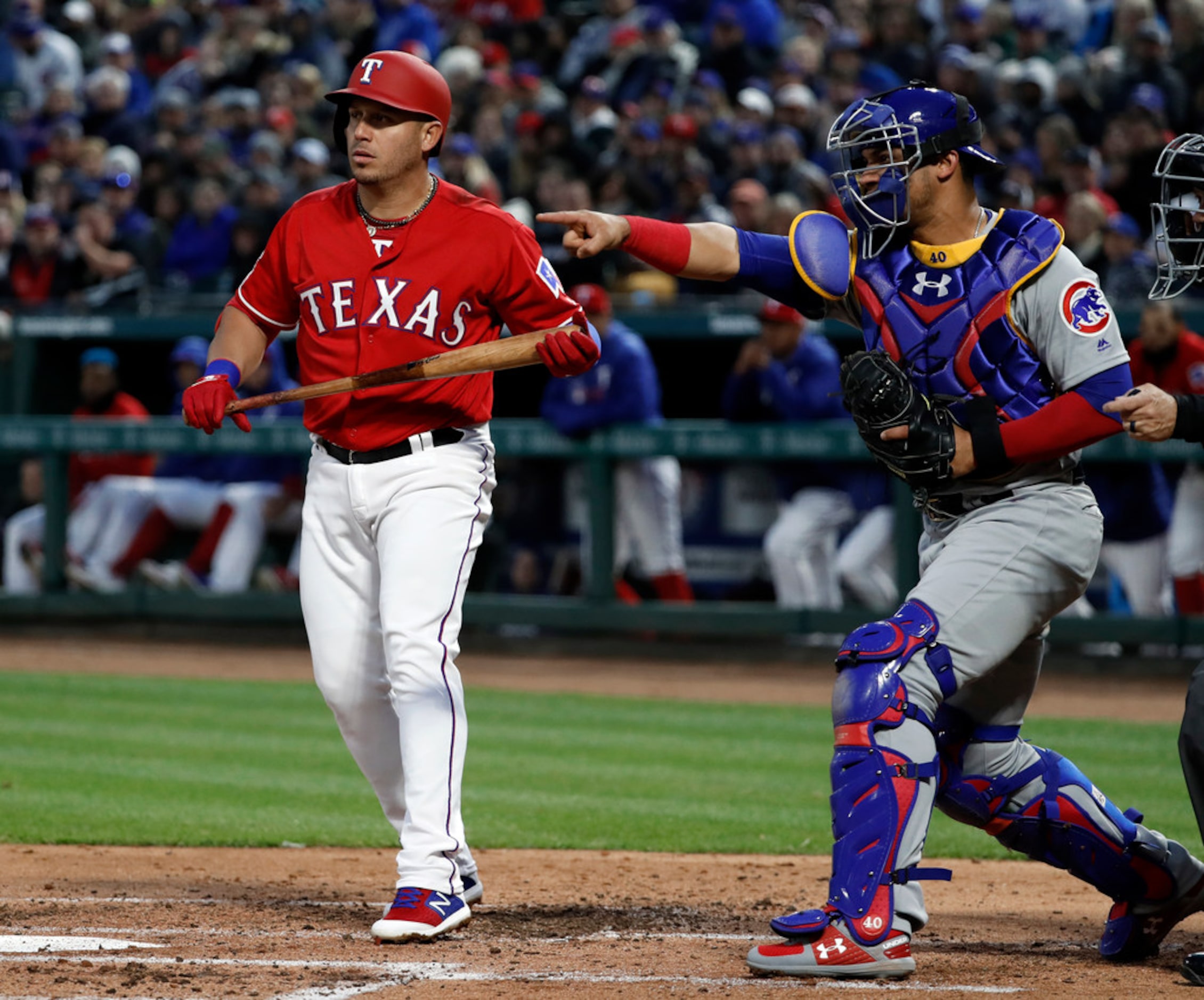 Texas Rangers' Asdrubal Cabrera, left, watches as Chicago Cubs catcher Willson Contreras,...