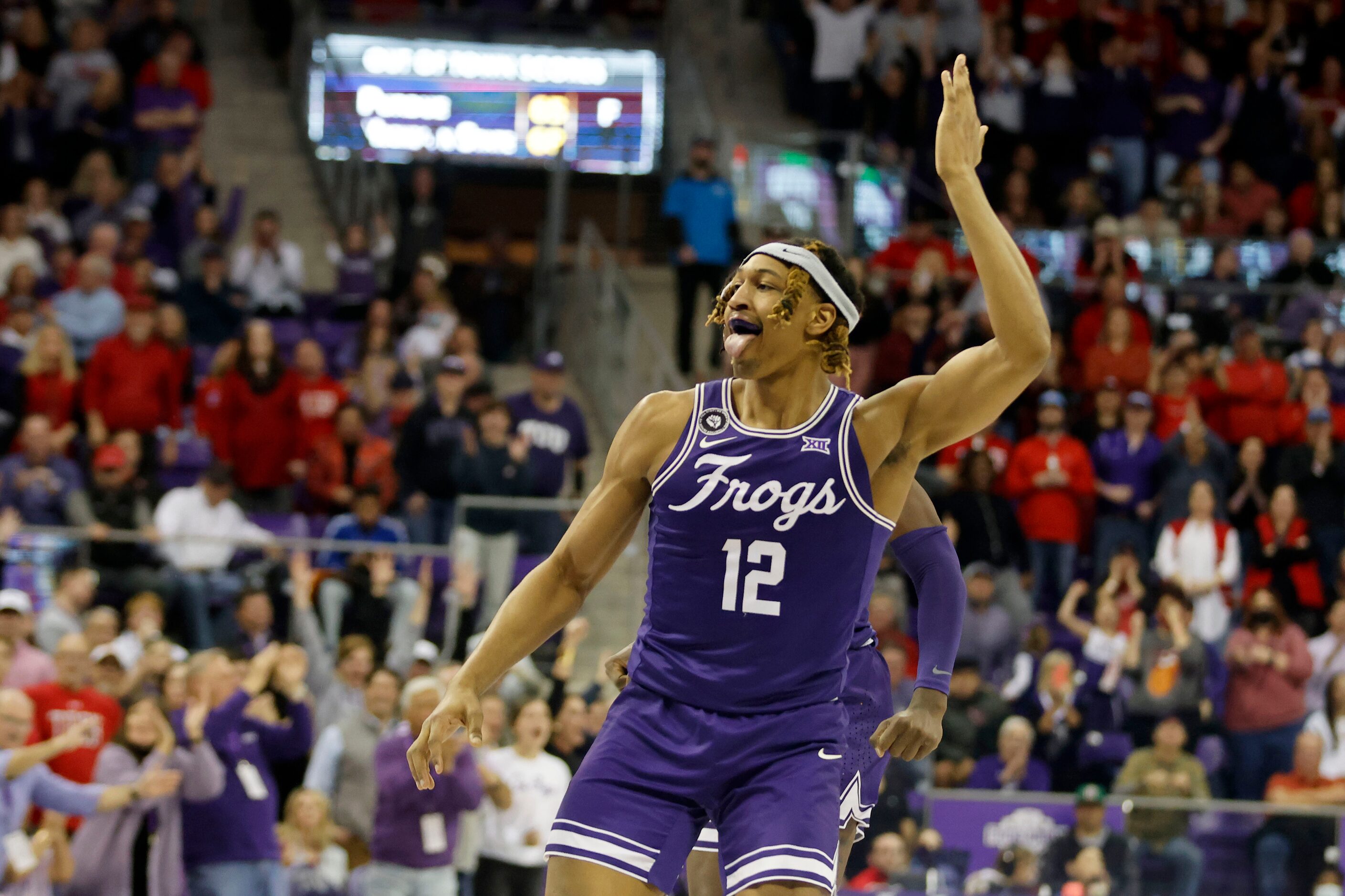 TCU forward Xavier Cork (12) reacts to his basket in the final minute of the secondbhalf of...