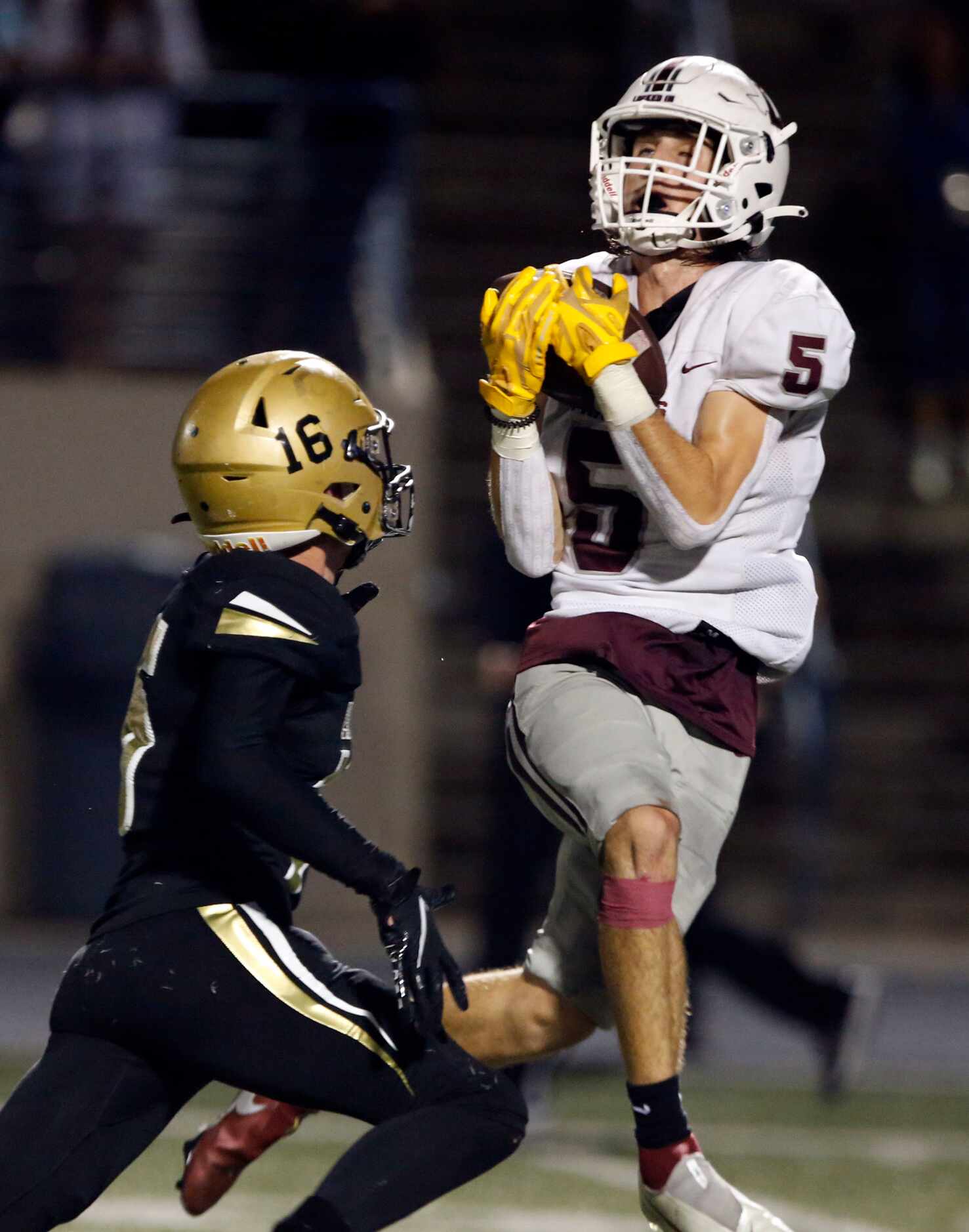 LewisvilleWR Brent Allen (5) catches a touchdown pass over Plano East defender Holden Stokes...