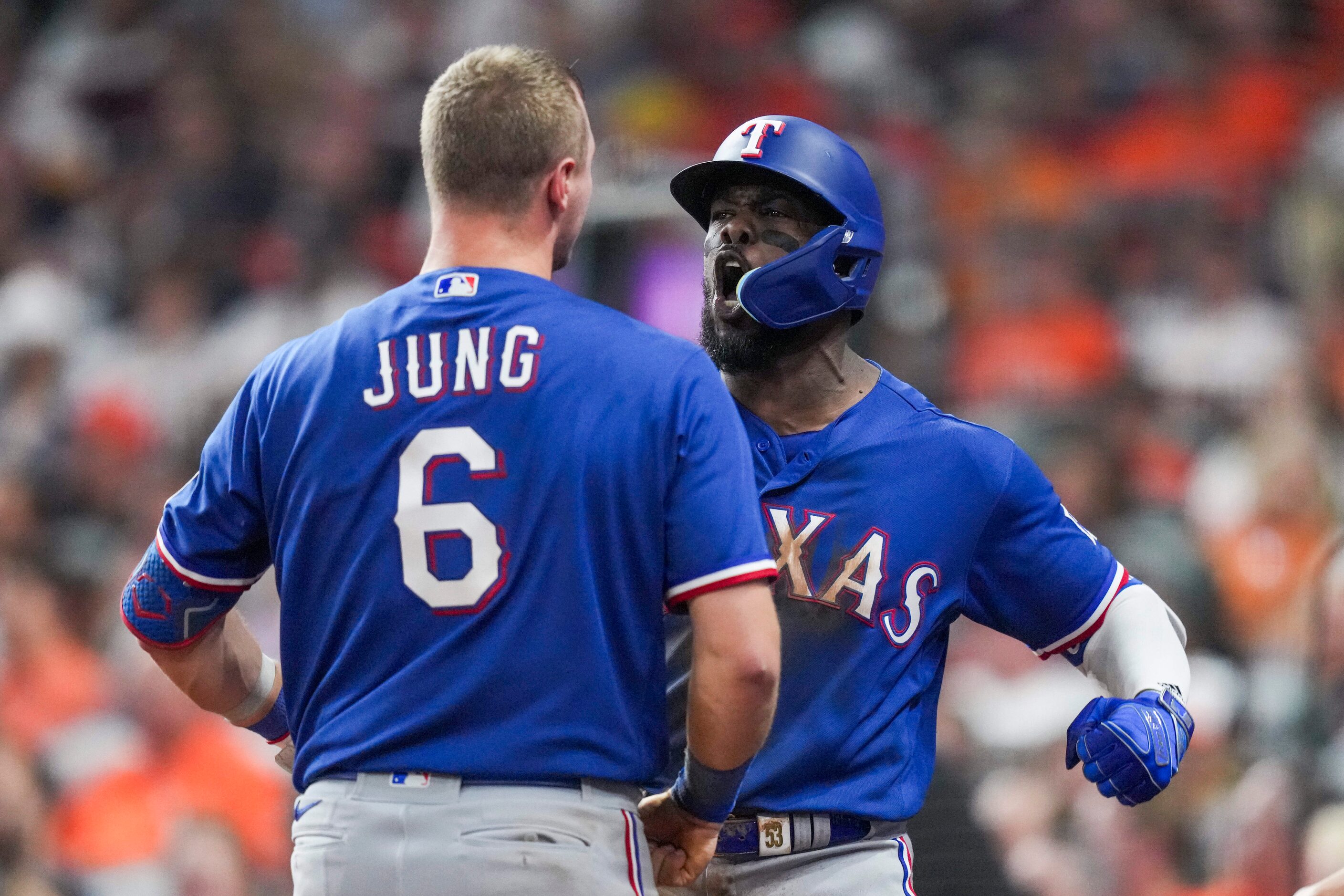 Texas Rangers right fielder Adolis Garcia (53) celebrates with third baseman Josh Jung (6)...