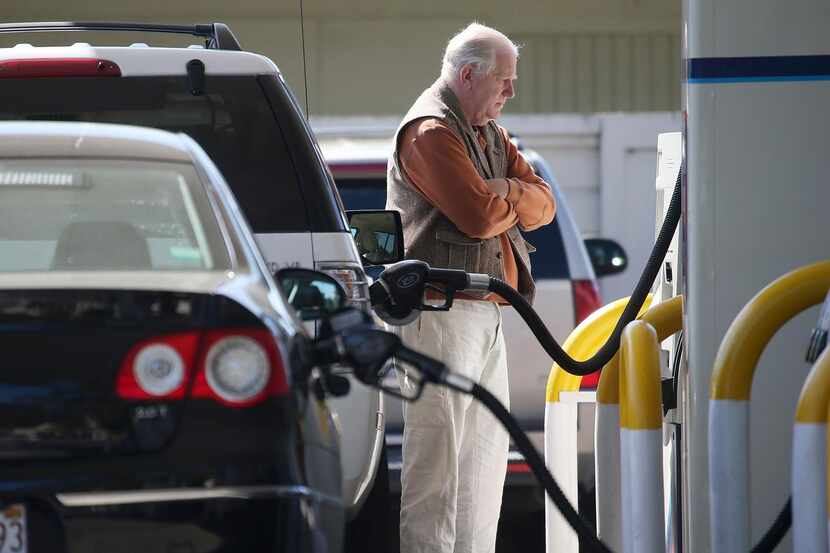 
A customer pumps gasoline at a Mill Valley, Calif., station. An industry analyst predicted...