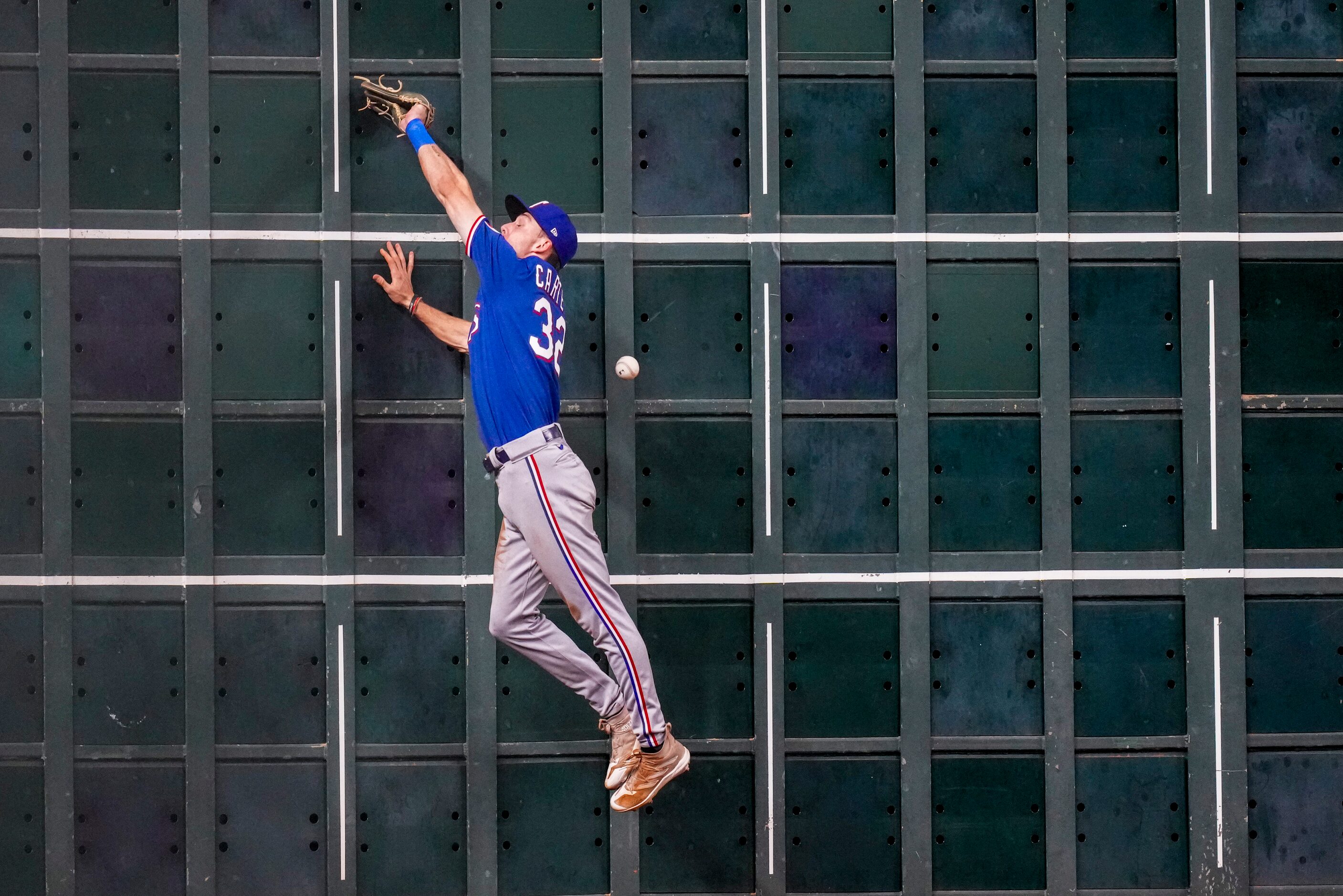 Texas Rangers left fielder Evan Carter can’t make the play on a triple hit by Houston Astros...