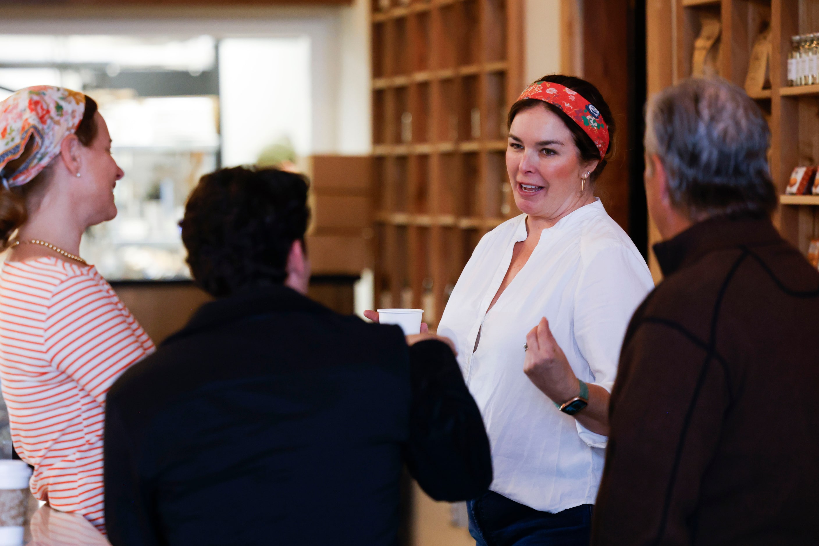 Owner Amy Wallace Cowan (center right) interacts with customers at Trades Delicatessen...