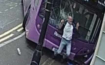 A still image from closed-circuit  video footage of the bus as it strikes Smith, just after...