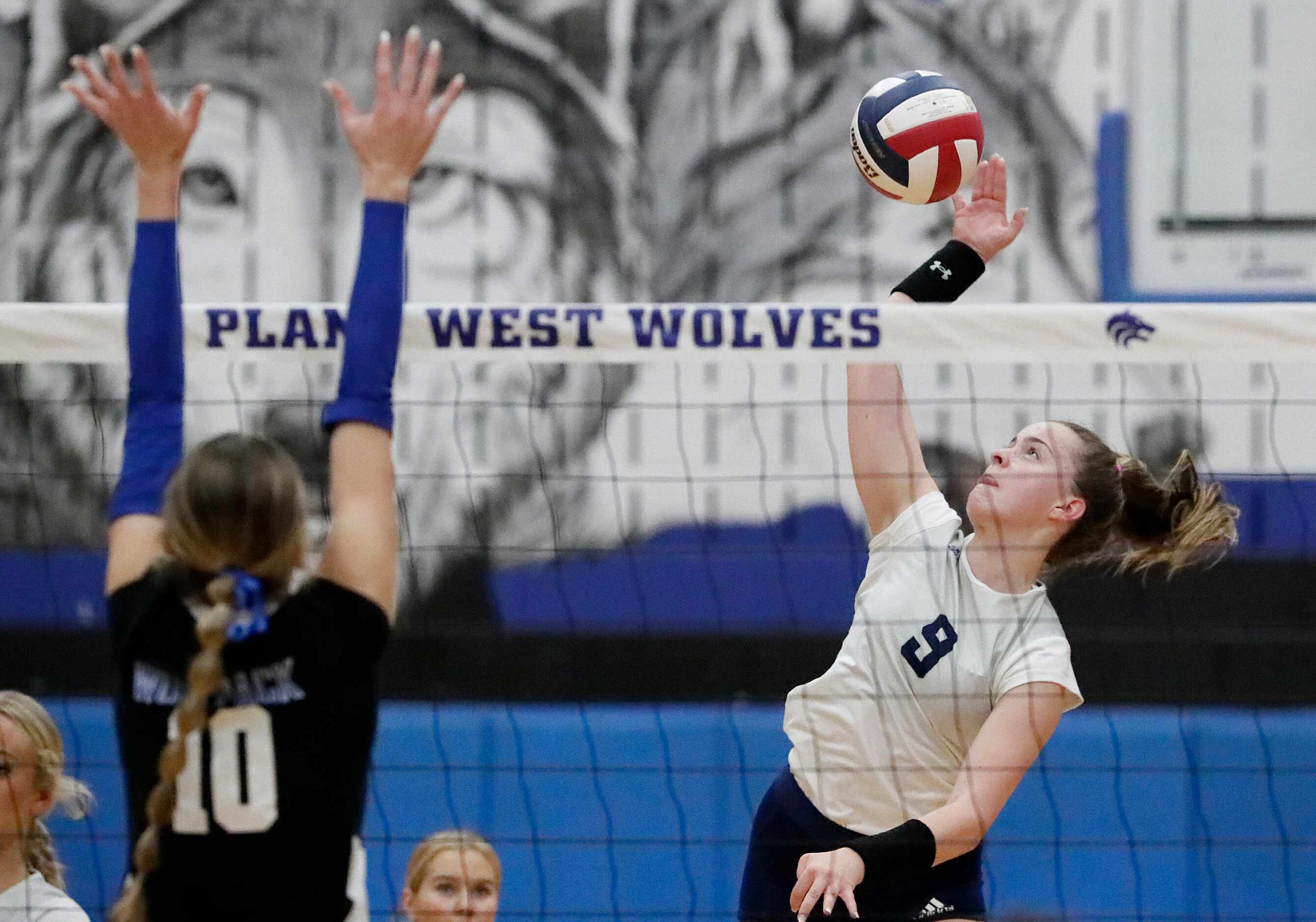 Flower Mound High School outside hitter Catherine Young (9) gets a hit during game one as...