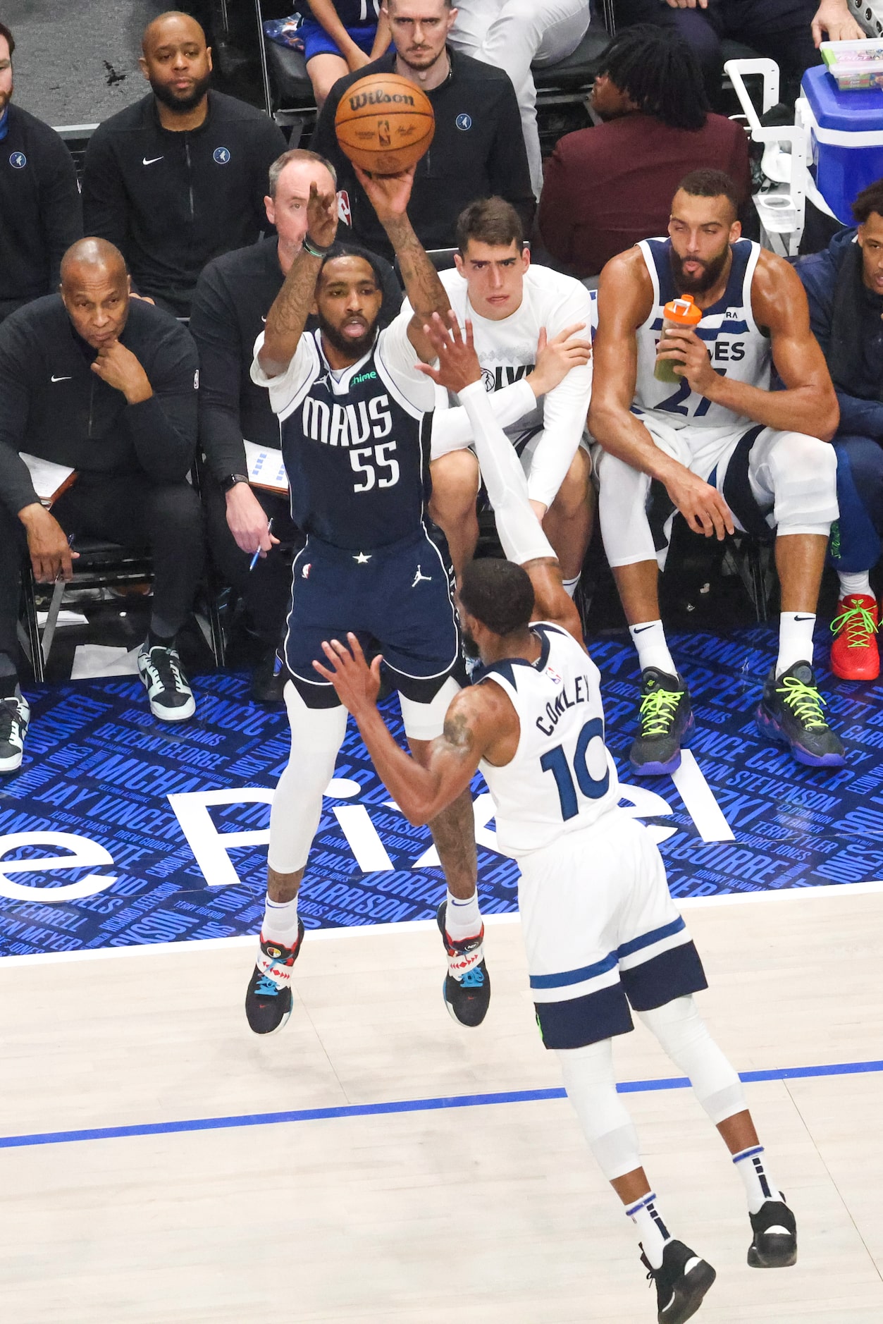 Dallas Mavericks forward Derrick Jones Jr. shoots a 3-pointer over Minnesota Timberwolves...