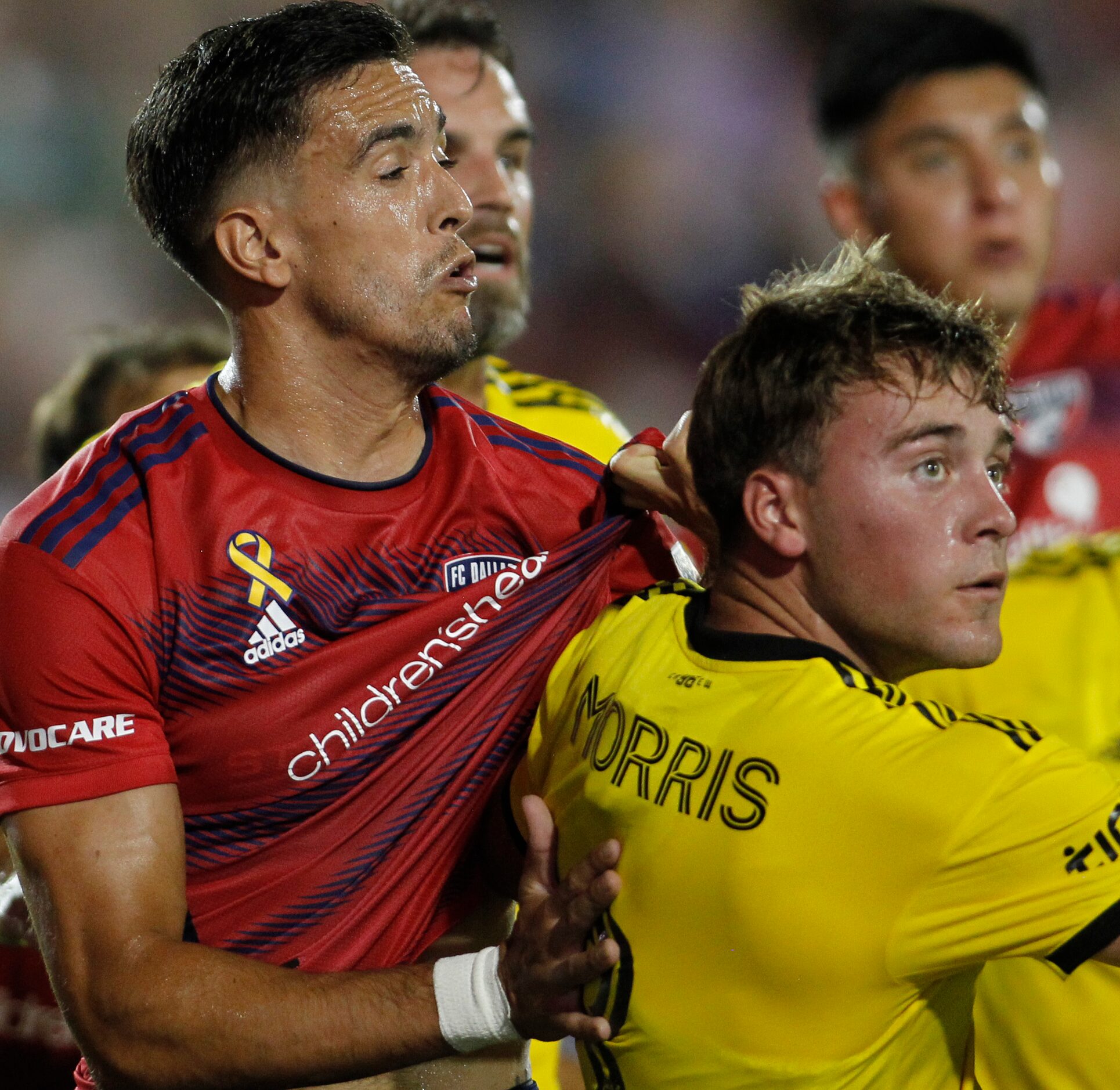 FC Dallas defender Jose Martinez (3), left, becomes tangled with Columbus midfielder Aidan...