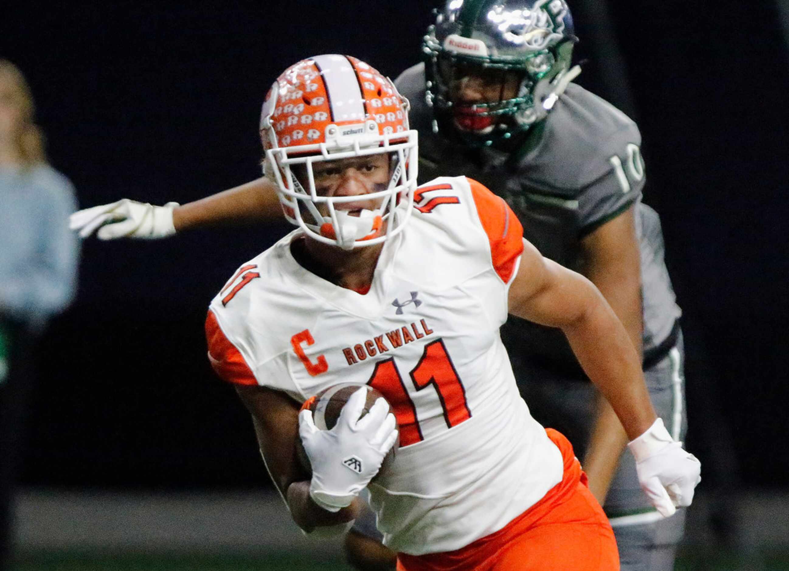 Rockwall High School wide receiver Jaxon Smith (11) scores a tochdown on this run after the...