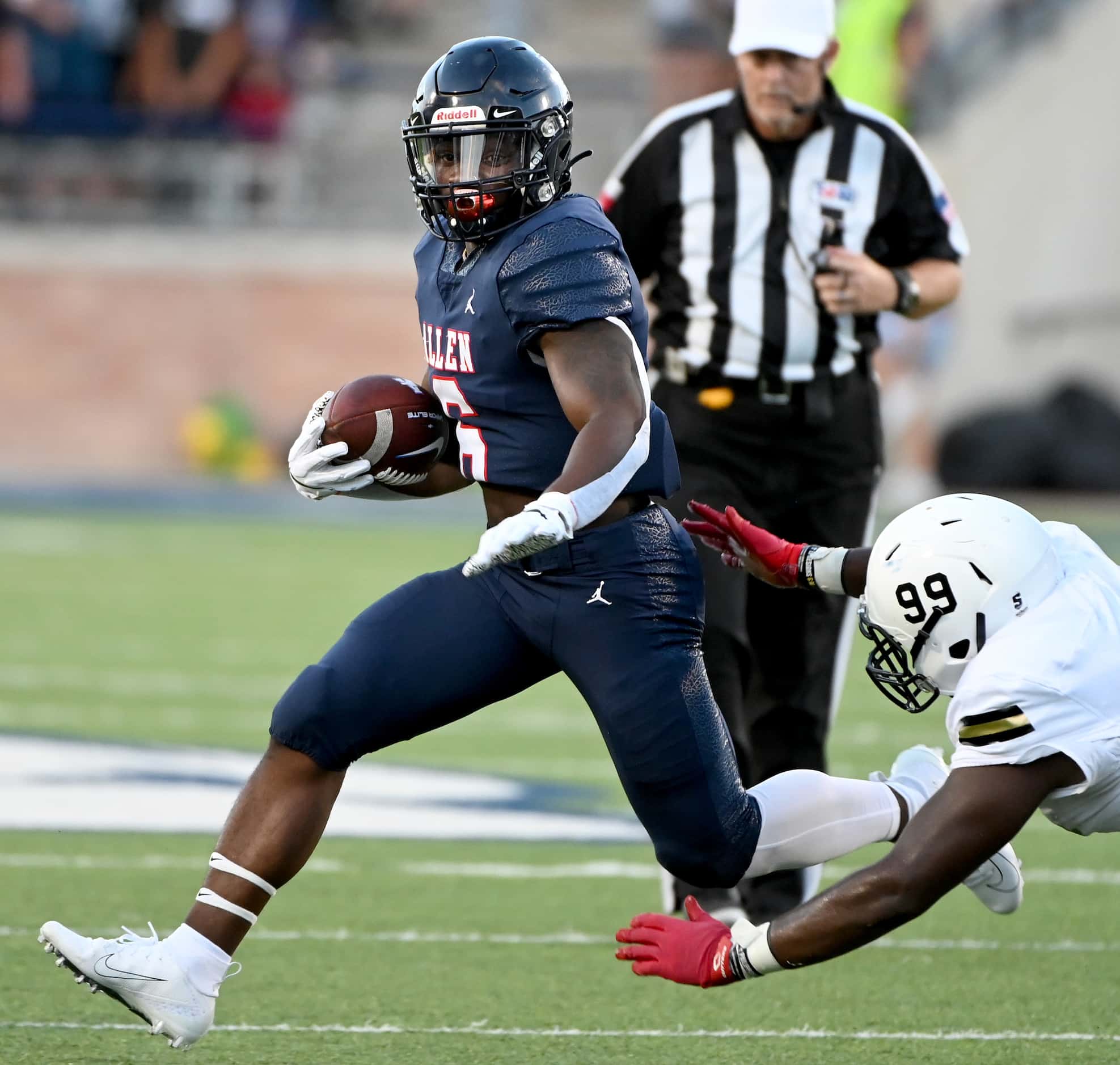 Allen’s Devyn Turner runs through a tackle attempt by Plano East’s Cedric Diggs (99) in the...