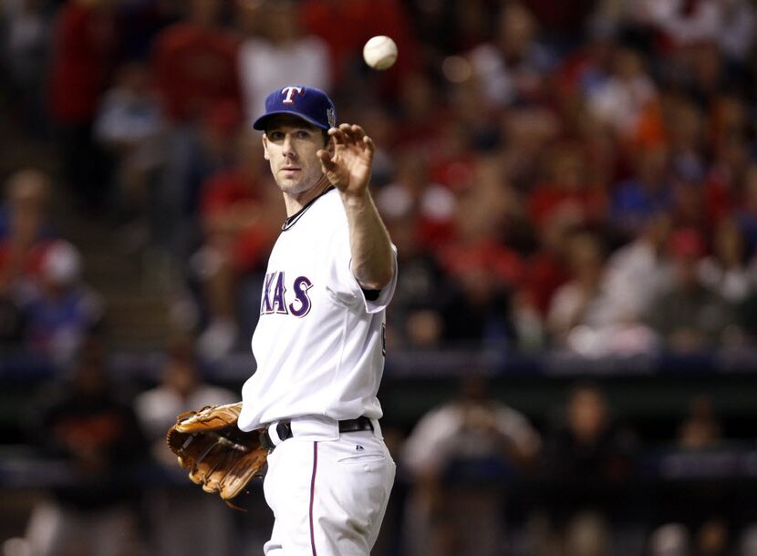 Texas Rangers Cliff Lee gets the ball back from Mitch Moreland after getting out San...