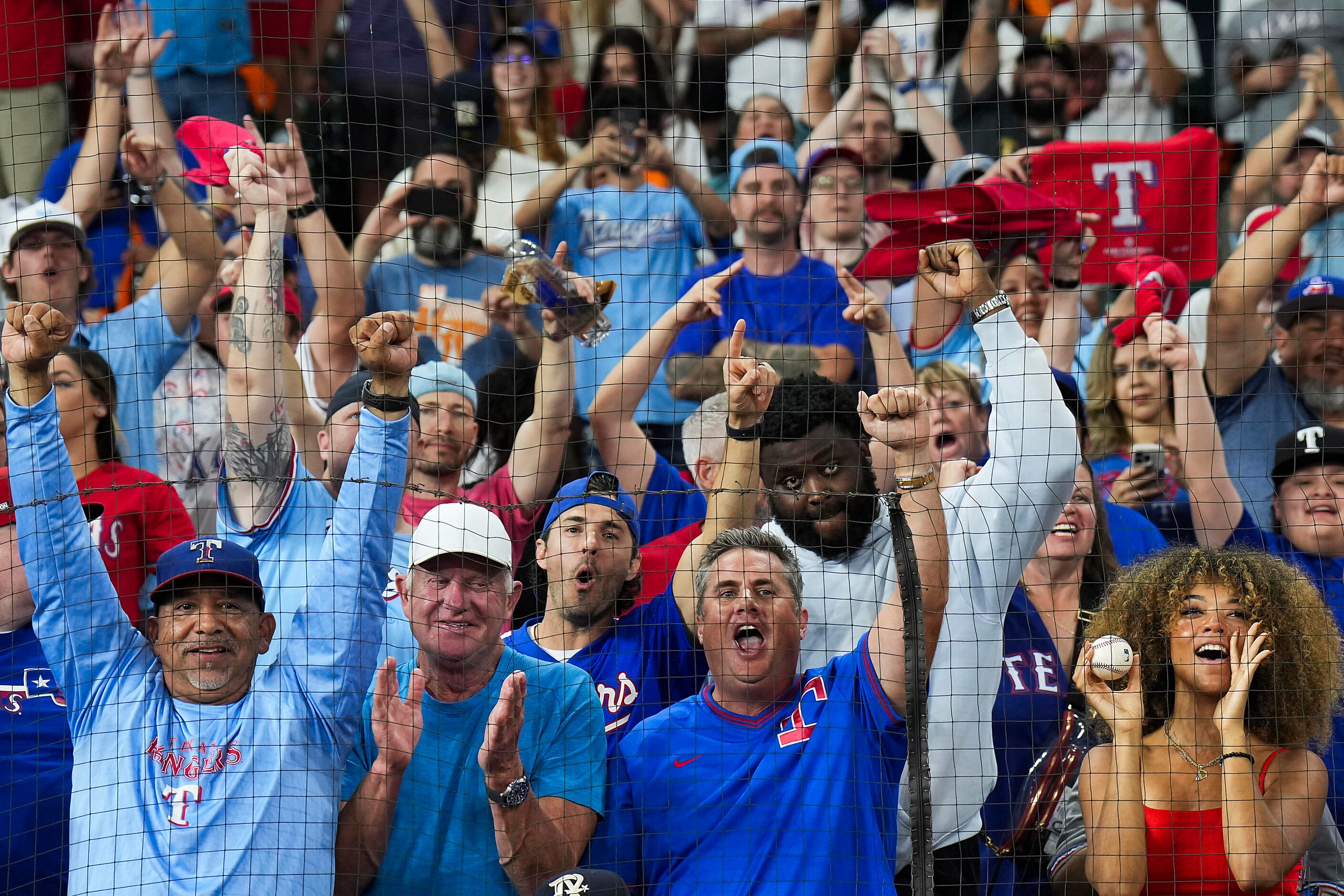 Texas Rangers fans celebrate after a victory over the Houston Astros in Game 7 of the...