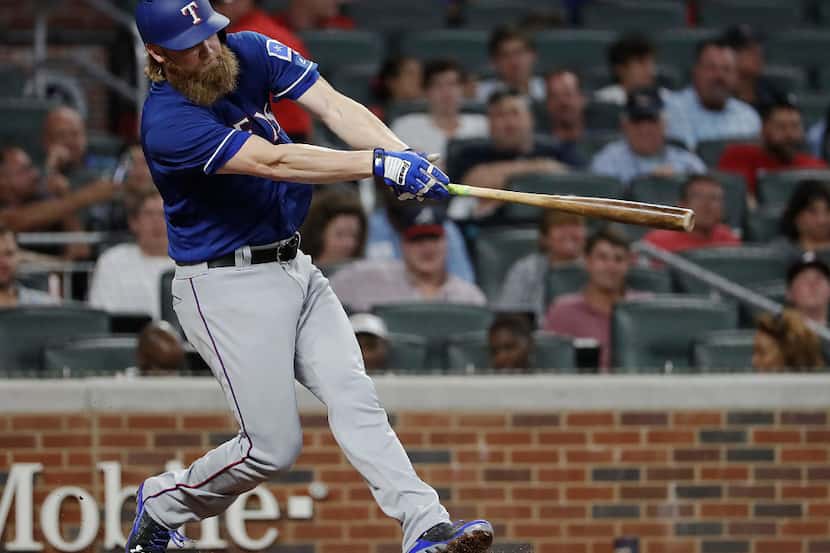 Texas Rangers' Andrew Cashner hits a sacrifice fly to score teammate Mike Napoli in the...
